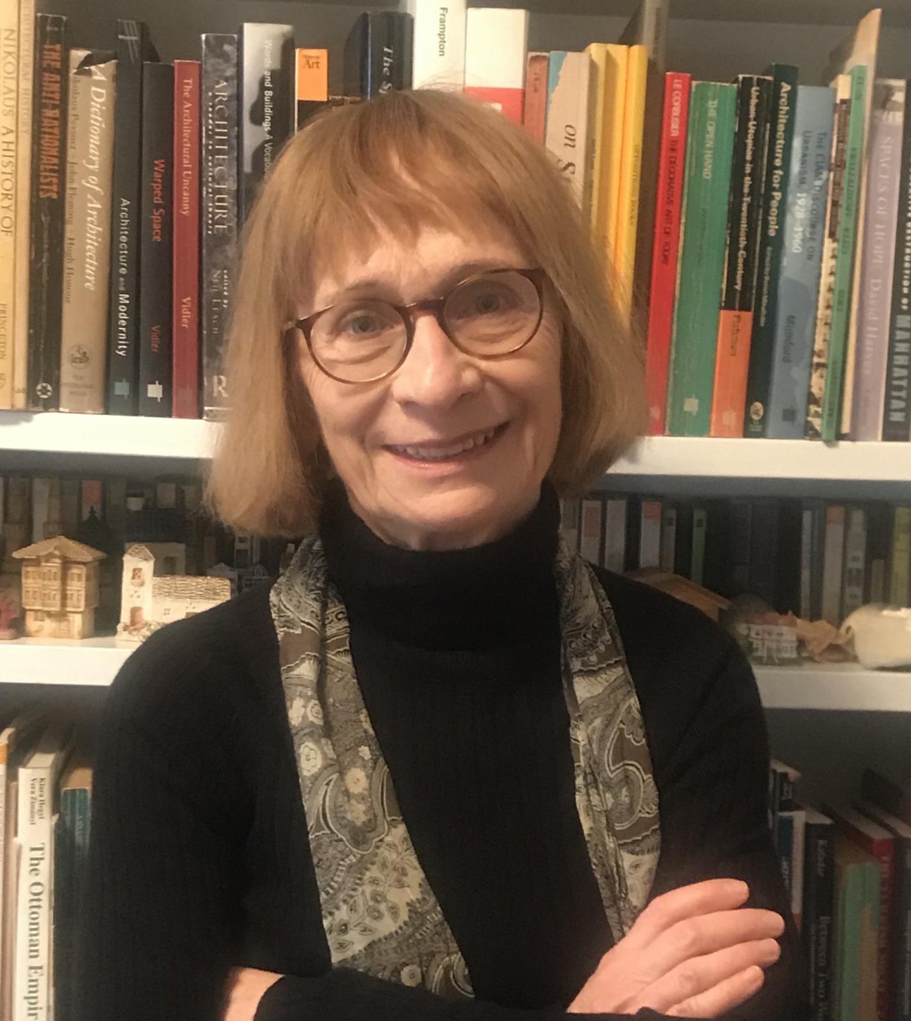 Headshot of Professor Zeynep Çelik, against a backdrop of bookshelves
